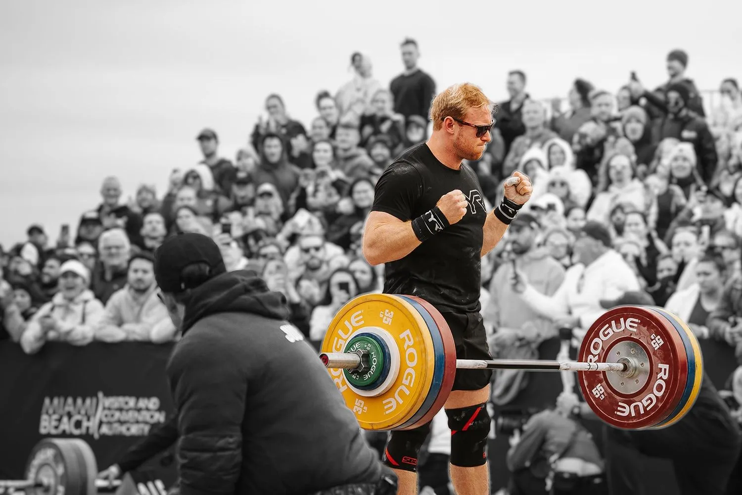 Pat Vellner lifting a barbell in front of a crowd at competition